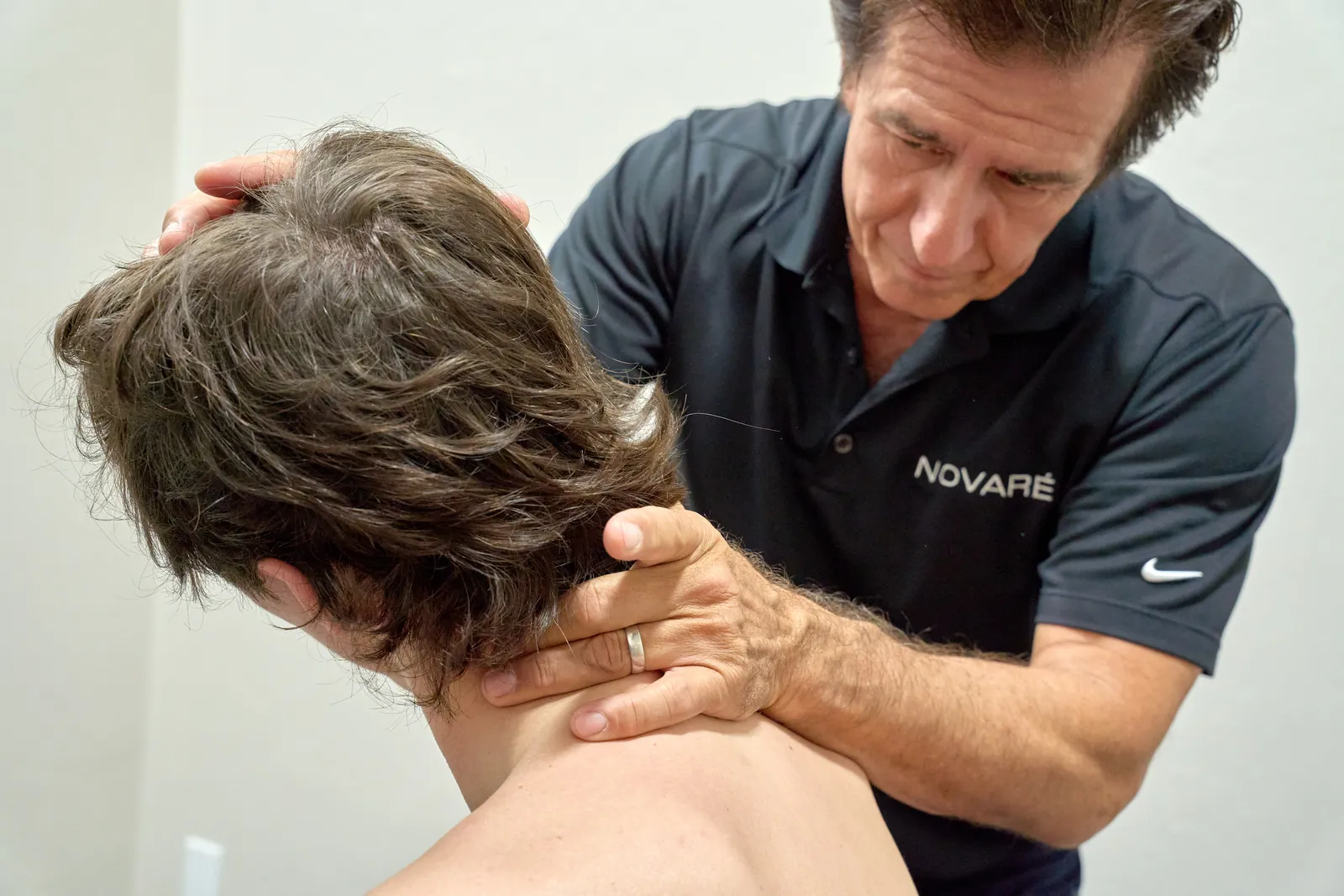 Dr. Ivan performing chiropractic evaluation at Novar&eacute; Injury Care
