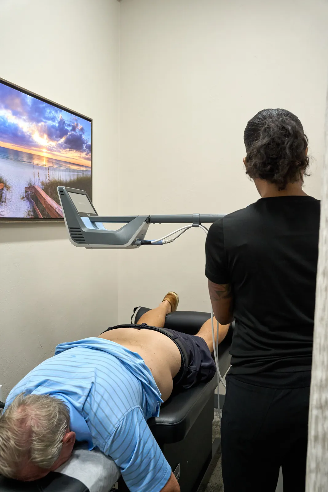 Dr. Ivan presenting treatment rooms at Novar&eacute; Injury Care